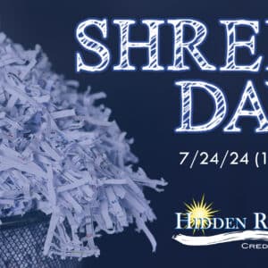 dark blue background with a trashcan full of shredded white paper on the left hand side. On the right it has white words that say "Shred Day' 7/24/24 (1-4pm). Under that is the HRCU logo